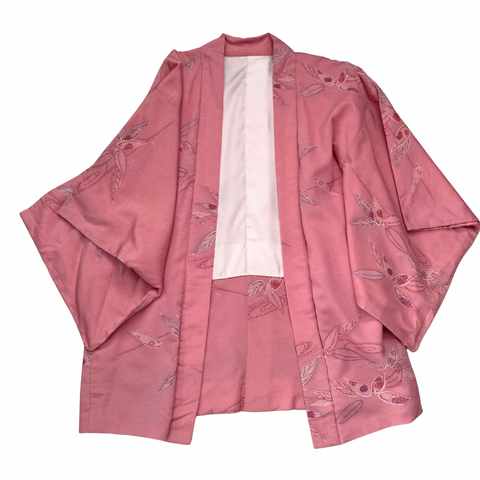 Pink kimono with floral patterns on a white background