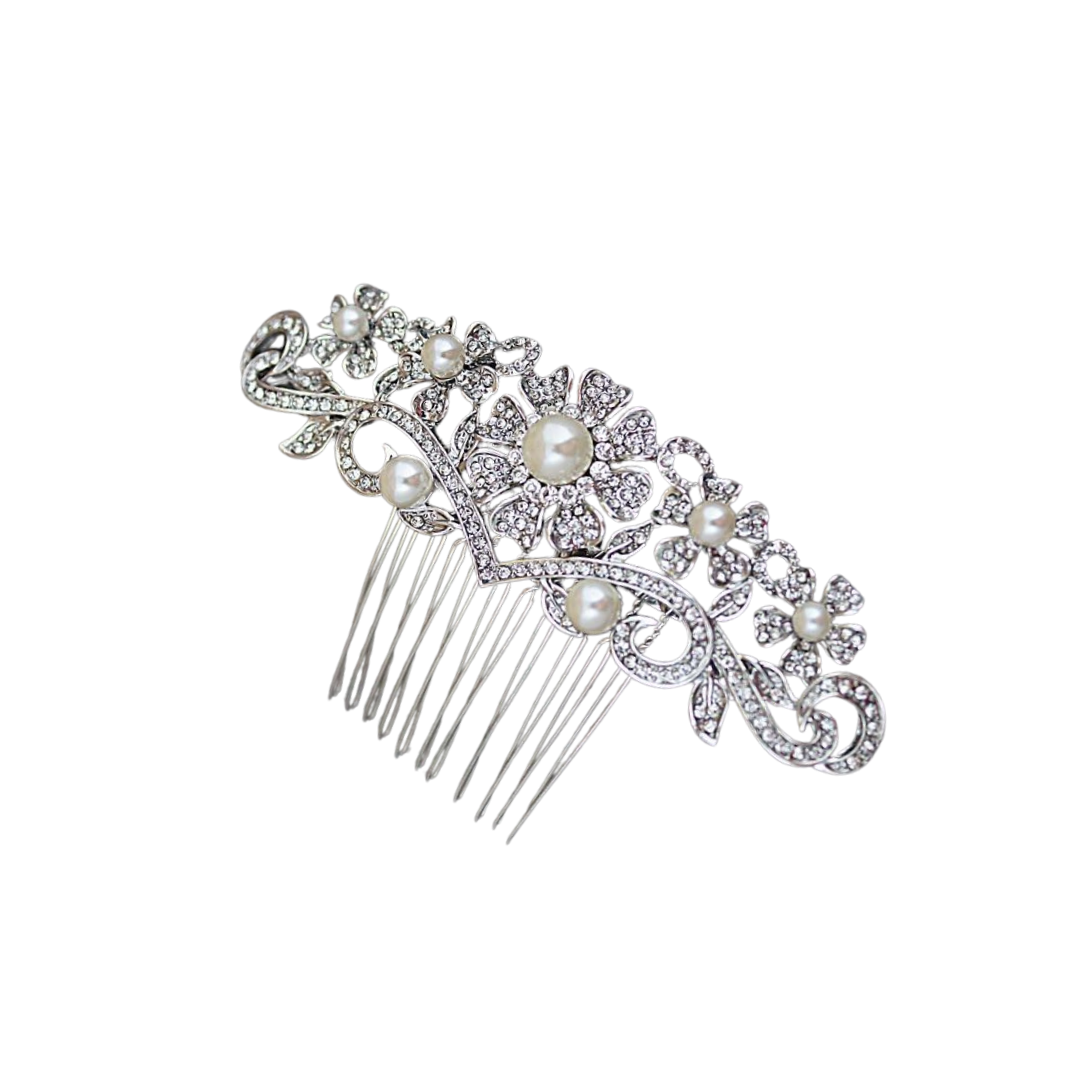 Decorative hair comb with pearls and crystals on a white background