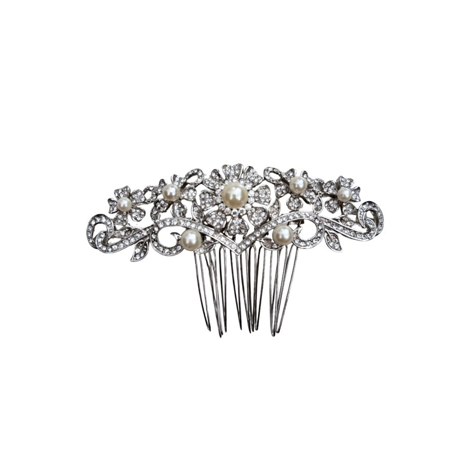 Decorative hair comb with pearls and crystals on a white background