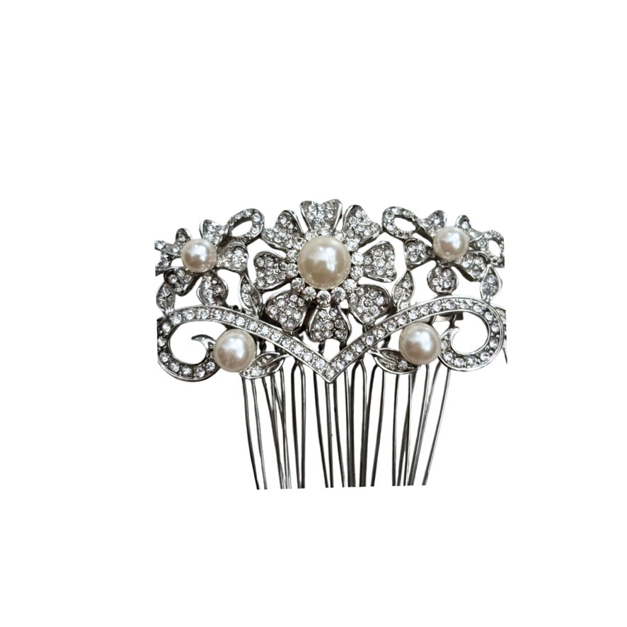 Decorative hair comb with pearls and crystals on a white background