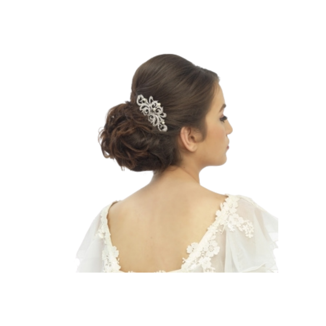 Woman with elegant hairpiece wearing a white lace garment on a white background