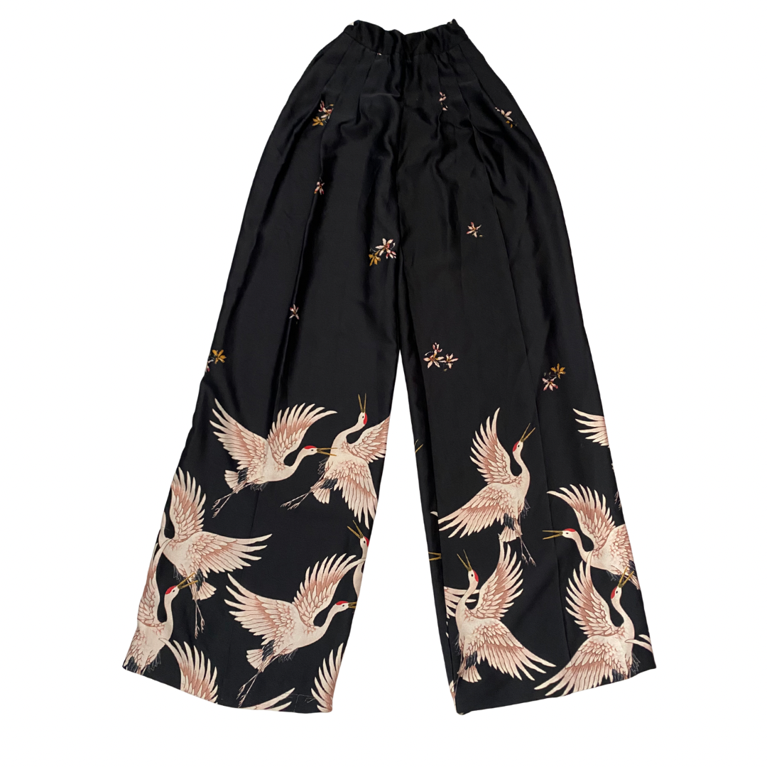Black pants with crane pattern on a white background