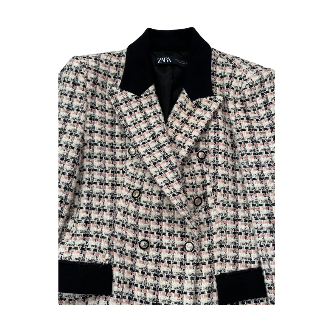 Plaid blazer with black trim on a white background