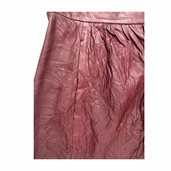 Close-up of a burgundy textured leather skirt pocket on a white background