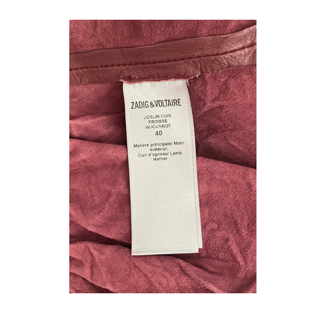 Close-up of a Zadig & Voltaire label on a burgundy leather product.