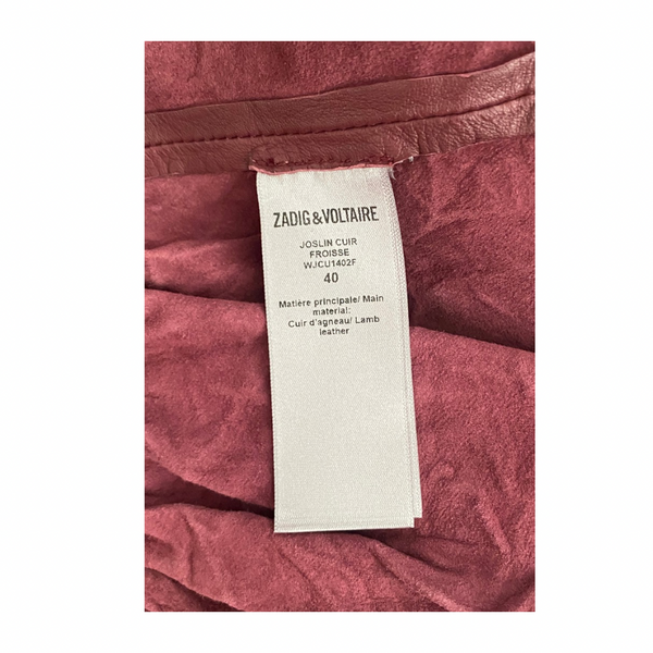 Close-up of a Zadig & Voltaire label on a burgundy leather product.