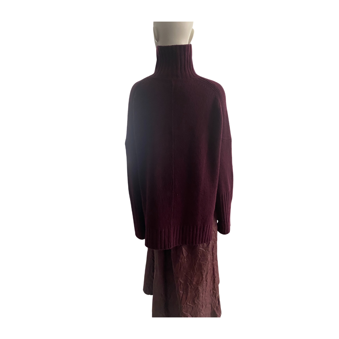 Mannequin wearing a burgundy sweater and skirt set on a white background