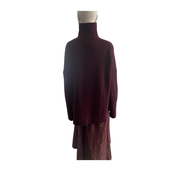 Mannequin wearing a burgundy sweater and skirt set on a white background