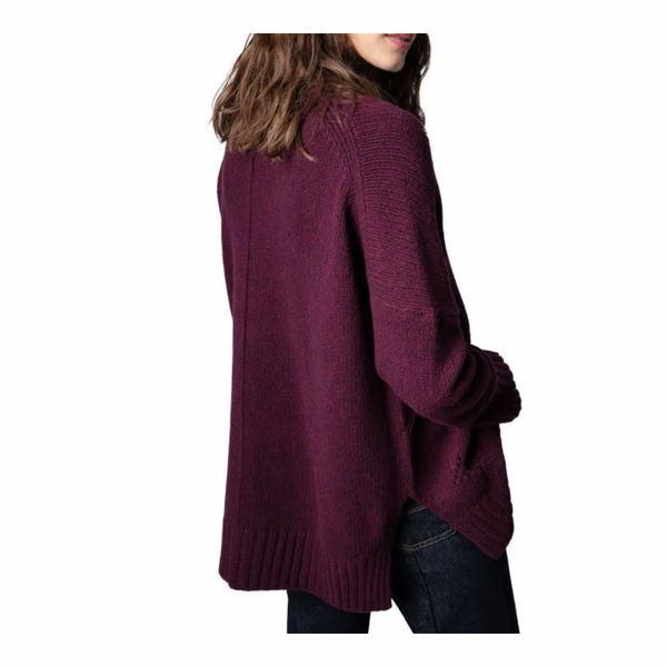 Burgundy sweater worn by a person on a white background