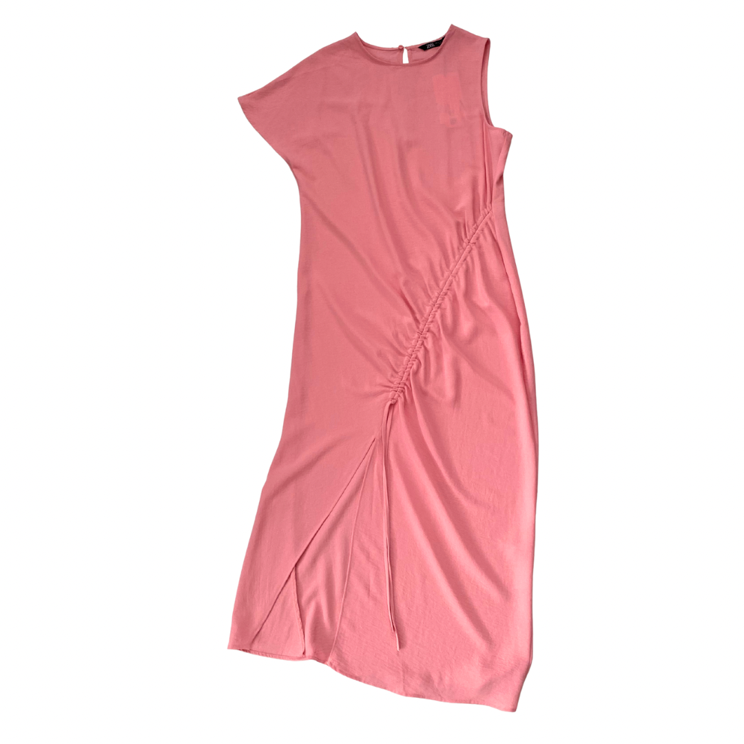 Pink dress with a side slit on a white background