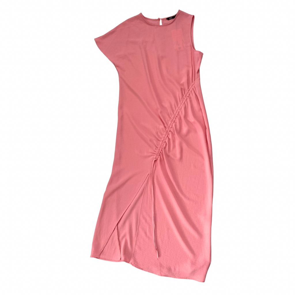 Pink dress with a side slit on a white background
