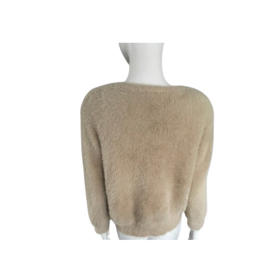 Beige sweater on a mannequin against a white background