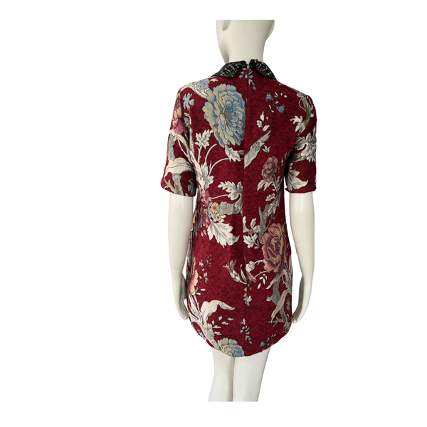 Red floral dress on a mannequin against a white background