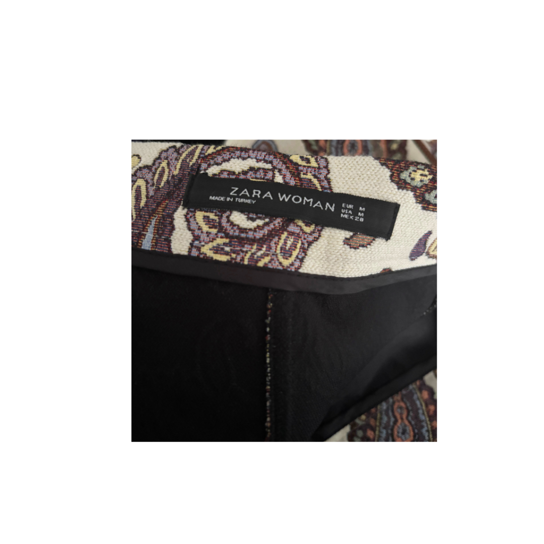 Zara Woman label on a garment with a patterned background