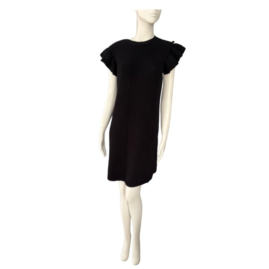 Black dress on a mannequin against a white background