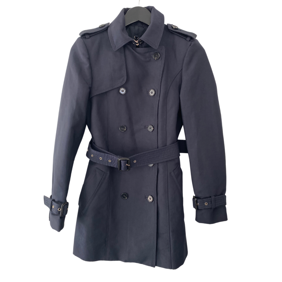 Navy mid-length double-breasted belted trench coat with side pockets, size XS, displayed on a hanger.
