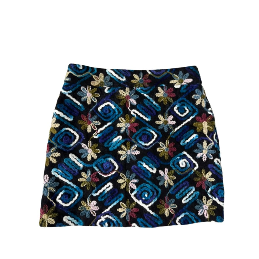 Patterned skirt with blue geometric design on a white background