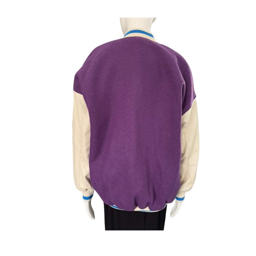 Purple sweater with beige sleeves on a mannequin against a white background