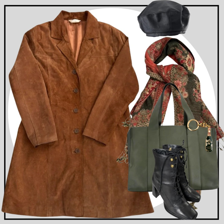 Brown suede coat with a black beret, patterned scarf, green handbag, and black boots on a white background.