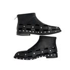 Black high-top shoes with studded design on a white background