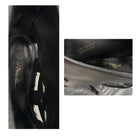 Close-up of a black leather product with visible branding and text.