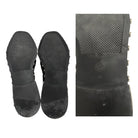 Black sole of a shoe with textured surface and brand logo on a white background