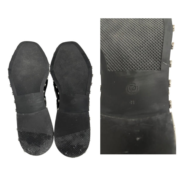 Black sole of a shoe with textured surface and brand logo on a white background