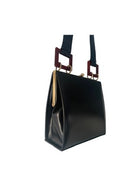 Black handbag with gold accents on a white background