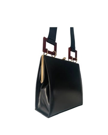 Black handbag with gold accents on a white background