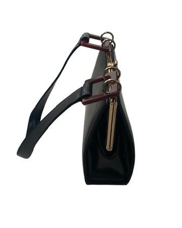Black handbag with a strap and gold clasp on a white background