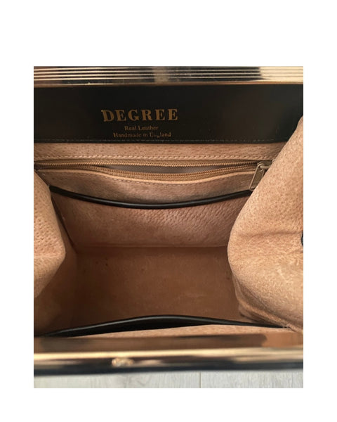 Close-up of a Degree leather product with visible stitching and brand name.