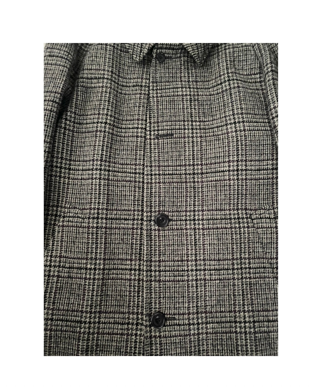 Gray checkered shirt with black buttons on a white background