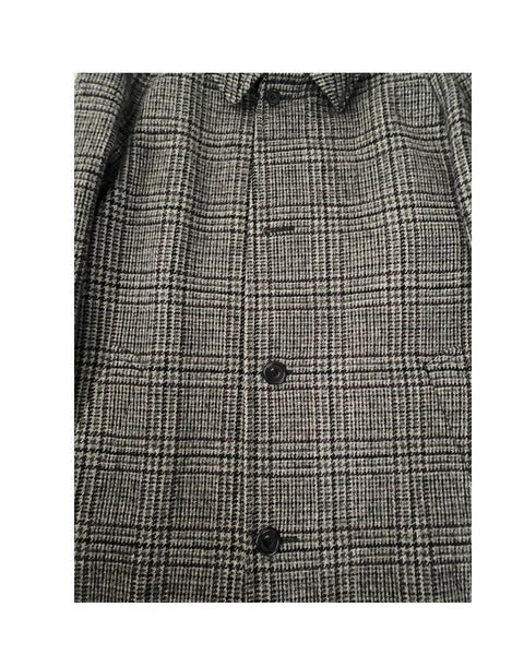 Gray checkered shirt with black buttons on a white background