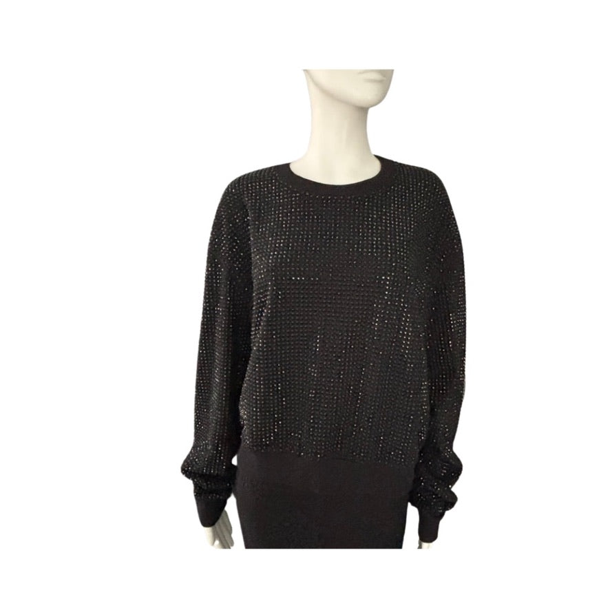 Black textured sweater on a mannequin against a white background