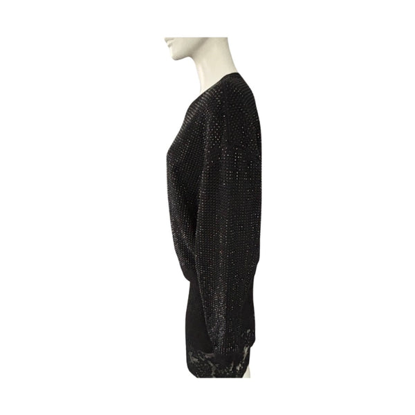 Black textured sweater on a mannequin against a white background