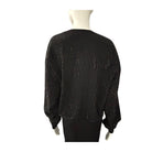 Black beaded sweater on a mannequin against a white background