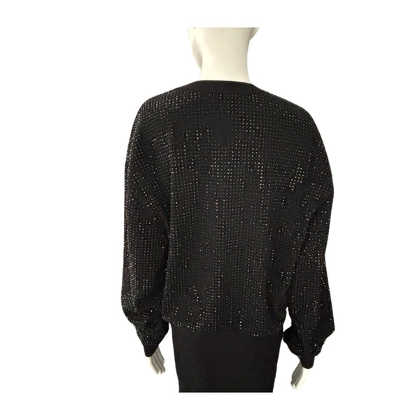 Black beaded sweater on a mannequin against a white background