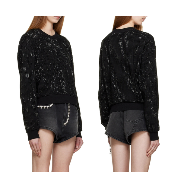 Black sequin sweater worn by a model on a white background