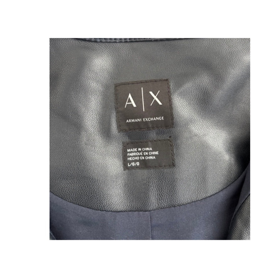 Close-up of Armani Exchange label on a gray fabric background