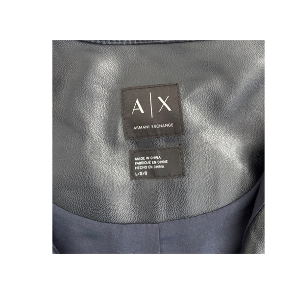 Close-up of Armani Exchange label on a gray fabric background