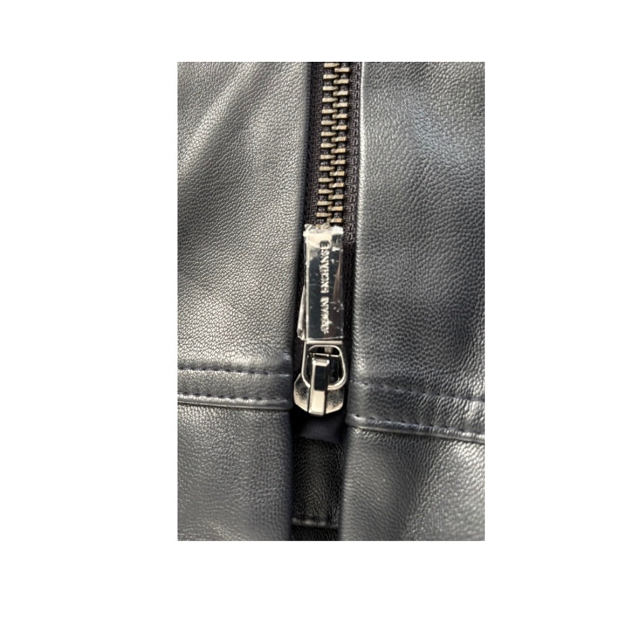 Close-up of a black leather jacket with a zipper on a white background