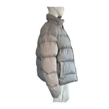 Grey puffer jacket on a mannequin against a white background