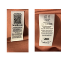 Clothing labels with QR code and text on a brown fabric background