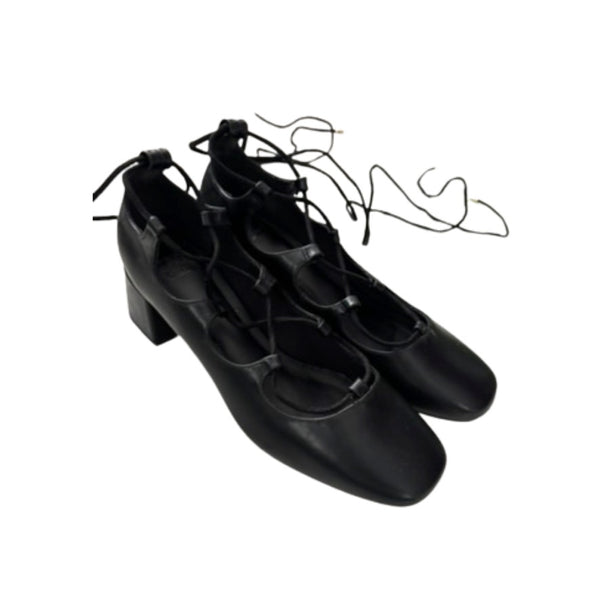 Pair of black tap shoes on a white background