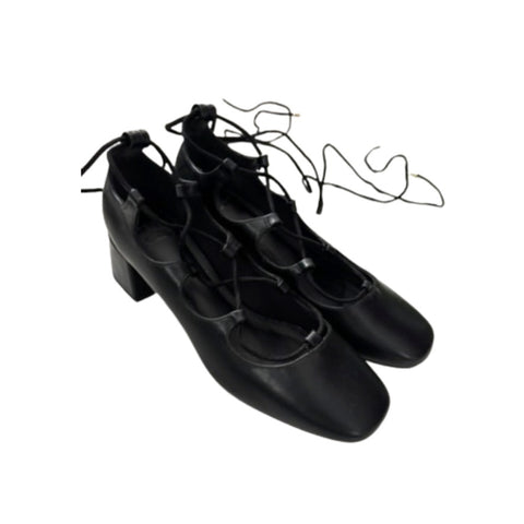 Pair of black tap shoes on a white background
