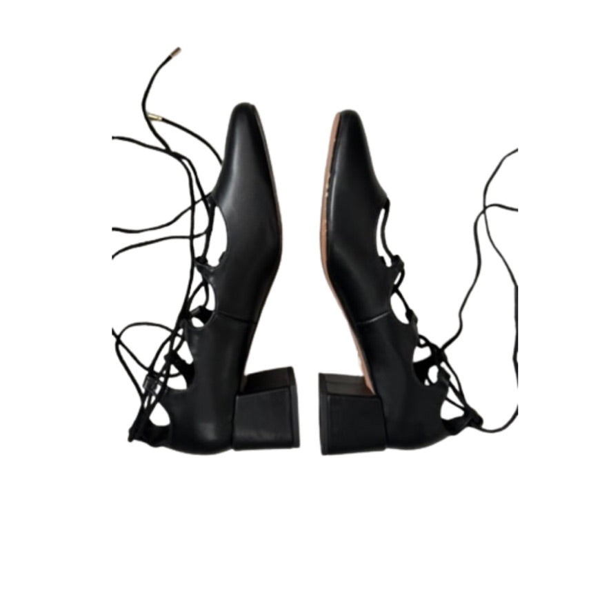 Pair of black lace-up high-heeled shoes on a white background