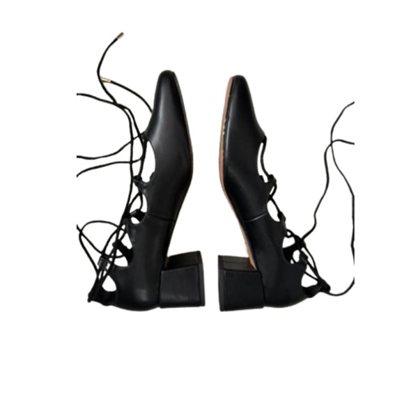 Pair of black lace-up high-heeled shoes on a white background