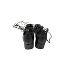 Pair of black dance shoes with laces on a white background