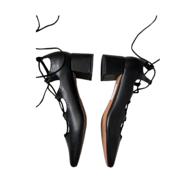 Black high-heeled shoes with unique design on a white background