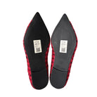 Red and black pointed-toe shoes on a white background